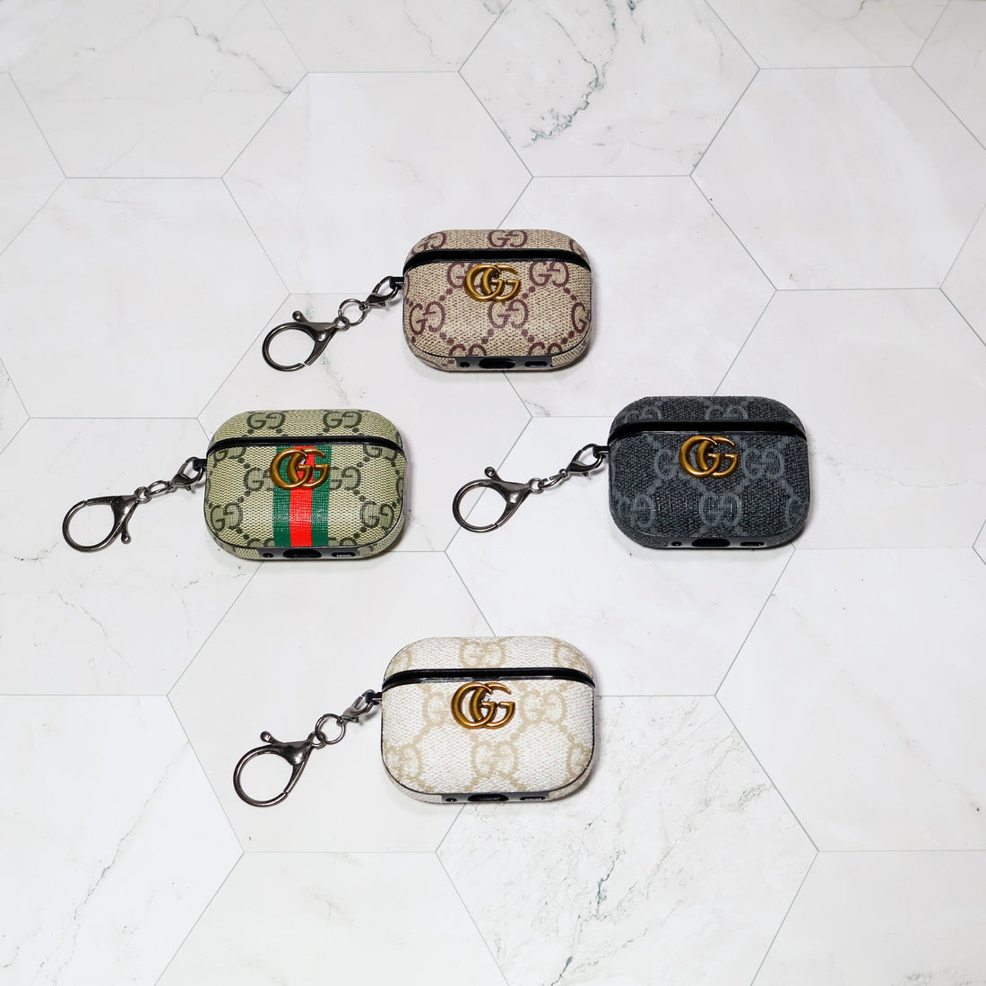 Four patterned AirPods covers with clip attachments