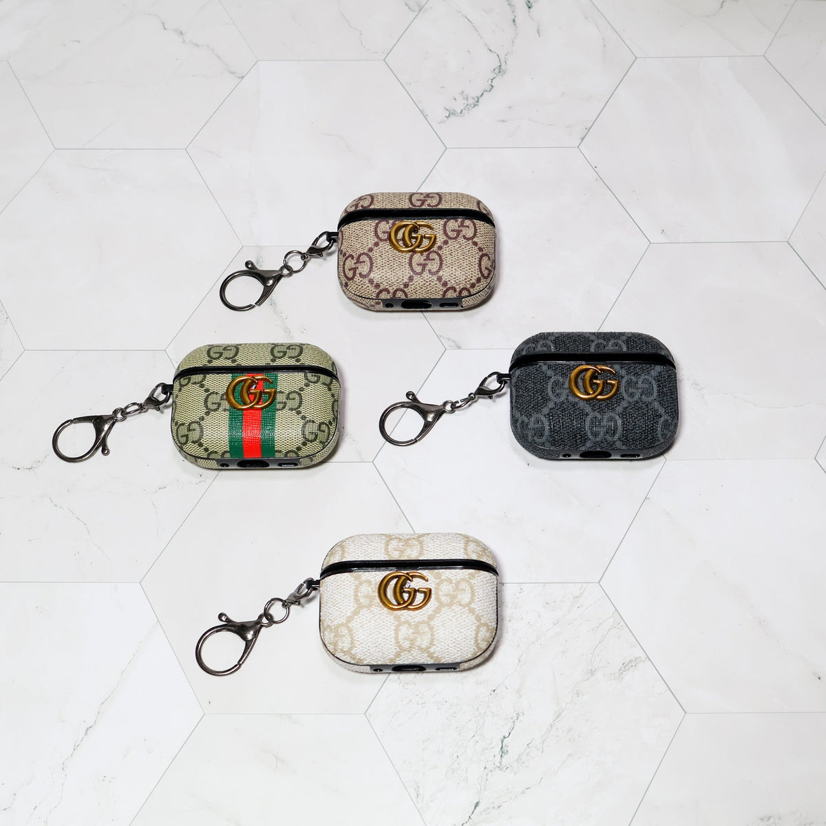 Four patterned AirPods covers with clip attachments