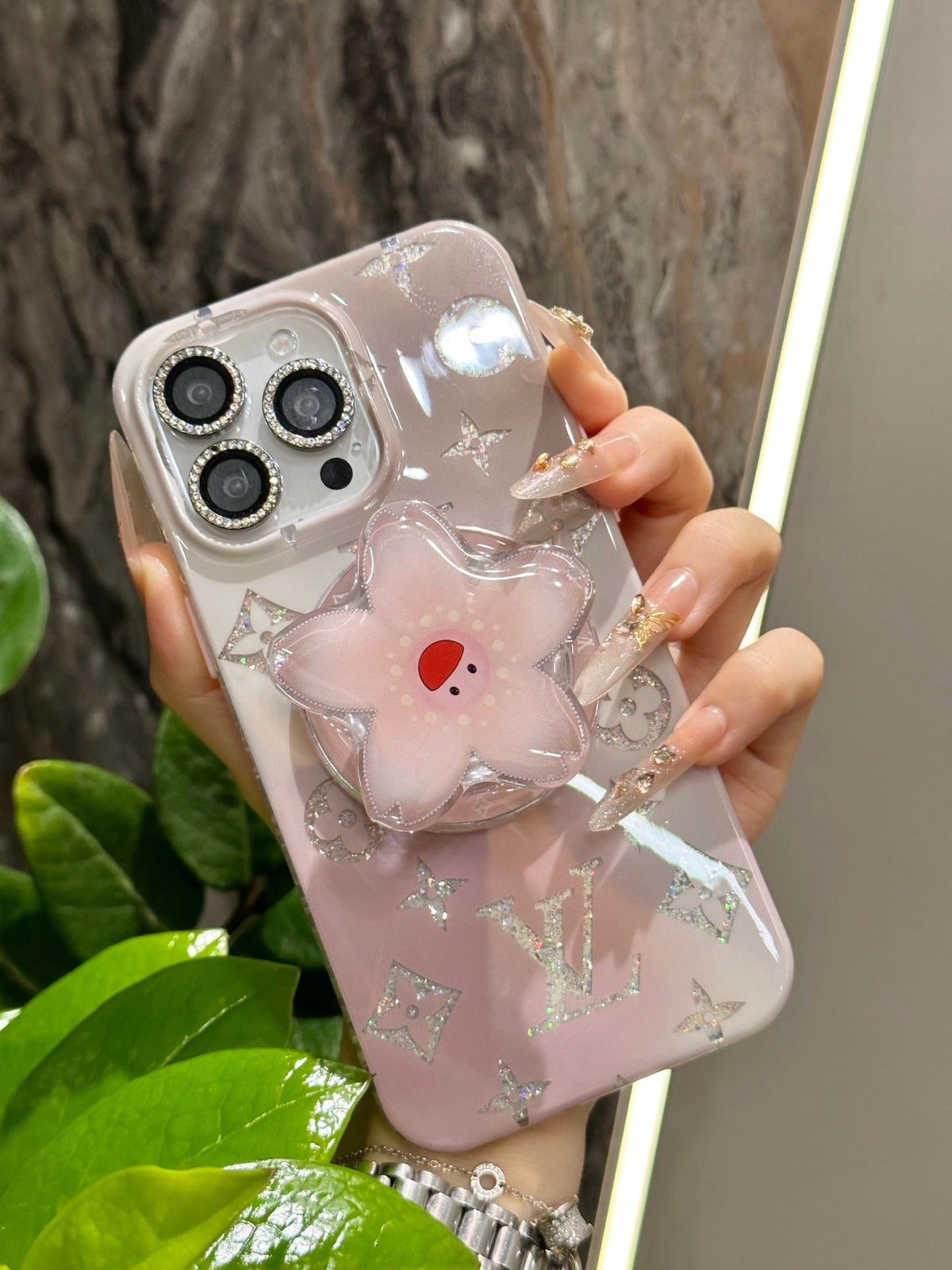 Pink iPhone case with a flower-shaped grip
