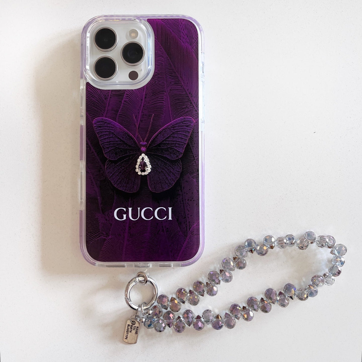 Purple butterfly iPhone case with a beaded wrist strap