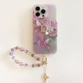Pale pink floral iPhone case with a beaded wrist strap