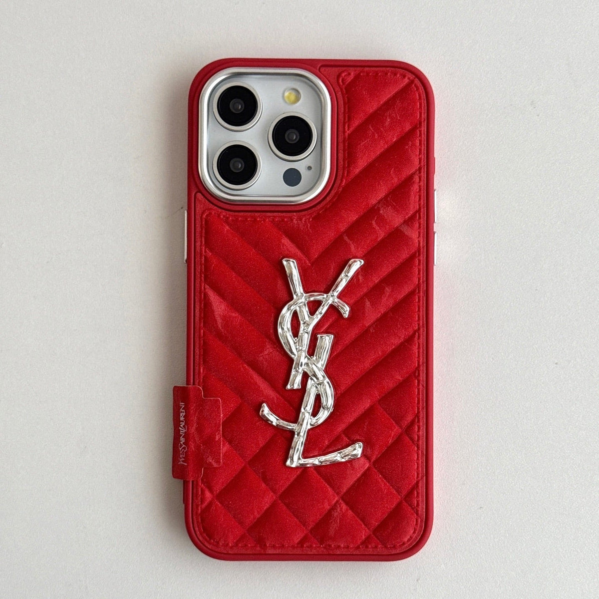 Red quilted iPhone case with a back grip tab and silver-tone initials