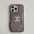 Taupe quilted iPhone case with a silver-tone emblem and side grip tab