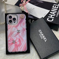 Pink marble-effect iPhone case with a black border and small logo accents