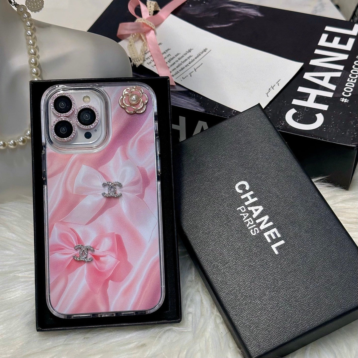 Pink marble-effect iPhone case with a black border and small logo accents