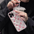 Clear pink monogram iPhone case shown in a hand-held product view
