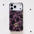 Purple and black floral monogram iPhone case with a gold-tone emblem