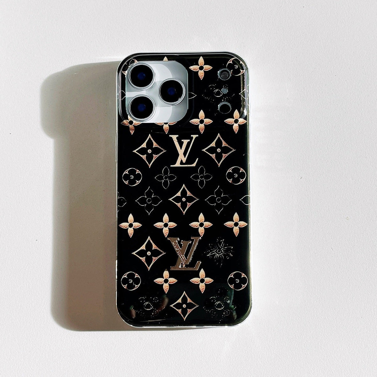 Black iPhone case with rose-gold monogram motifs