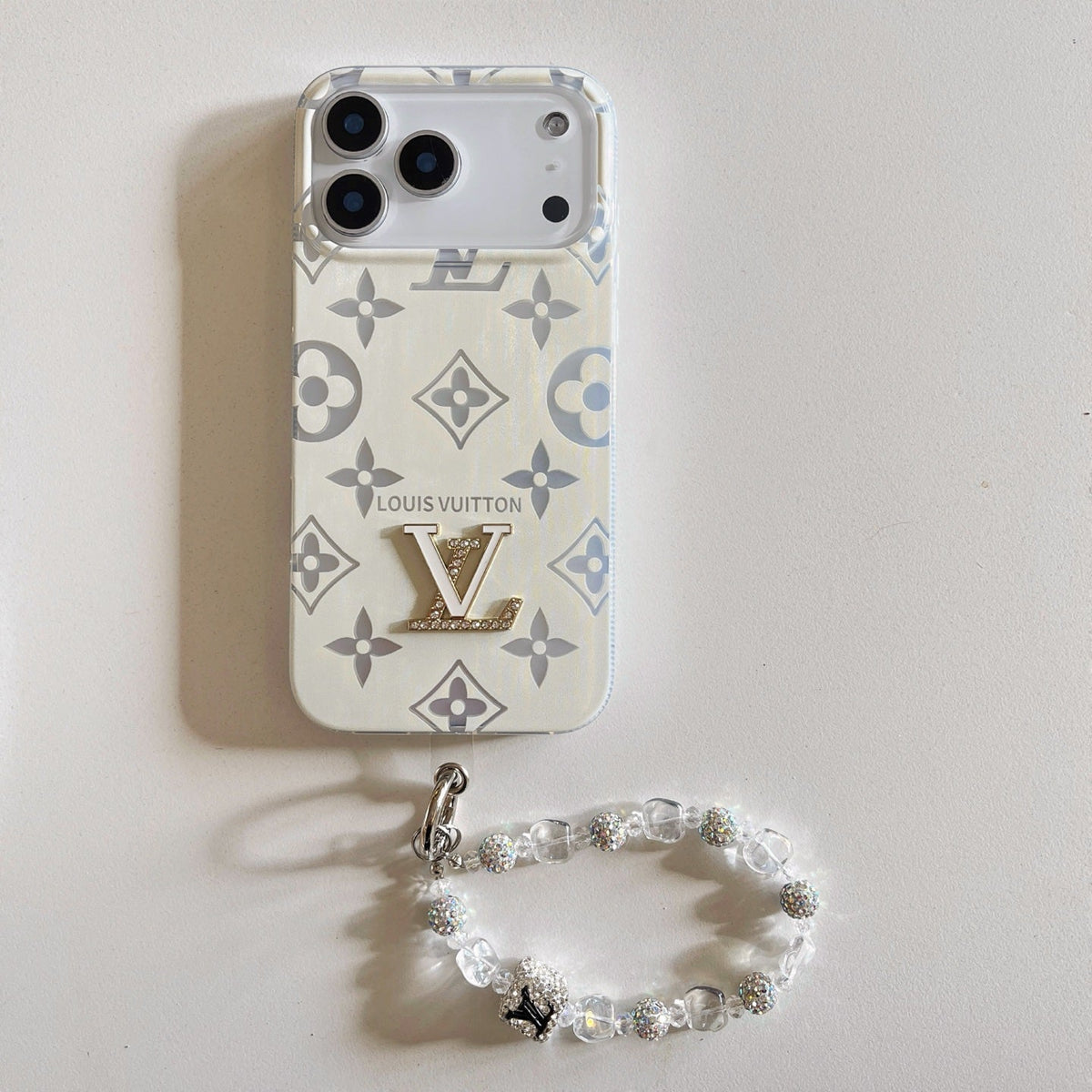 White and gray monogram iPhone case with a beaded wrist strap