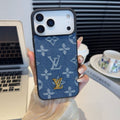 Blue monogram iPhone case with a raised gold-tone center emblem
