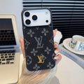 Black and gray monogram iPhone case with a raised gold-tone center emblem