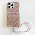 Blush monogram-print iPhone case with a beaded wrist strap