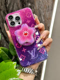 Bright pink and purple iPhone case with a three-dimensional flower grip