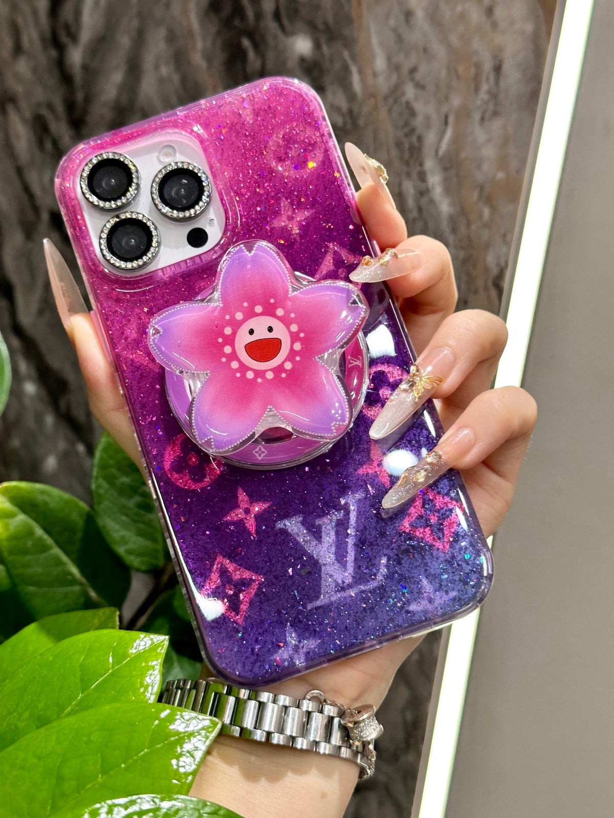Bright pink and purple iPhone case with a three-dimensional flower grip