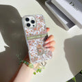 Floral monogram iPhone case shown in a hand-held product view