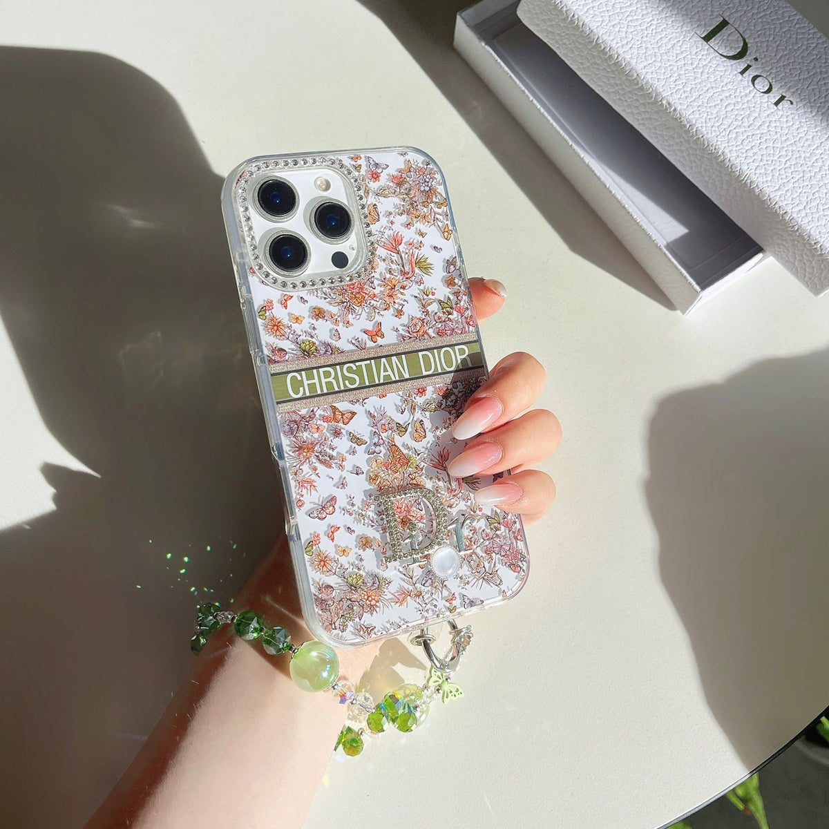 Floral monogram iPhone case shown in a hand-held product view