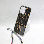 Close-up of the black LV iPhone case highlighting the golden monogram pattern and leather finish