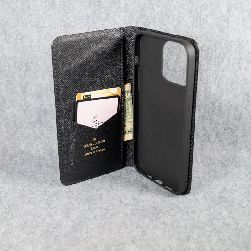 Black LV iPhone wallet case interior view showing the card storage and fitted phone shell