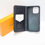 Close-up of the black LV wallet phone case showing leather texture and wallet detail