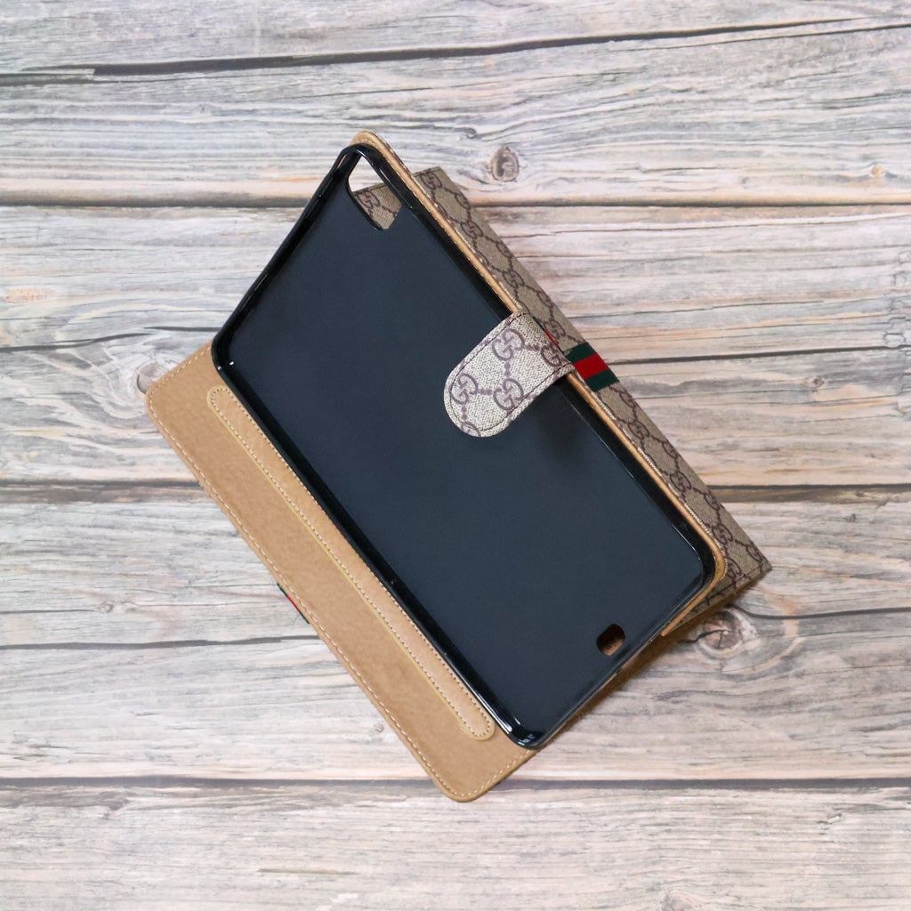 Close-up of the GG iPad case showing the patterned cover and folding folio construction