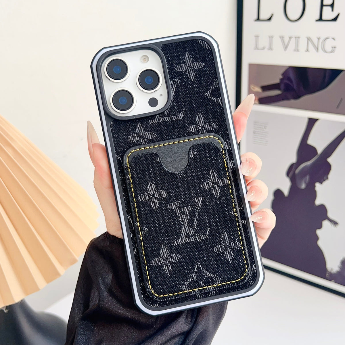 Black fabric LV iPhone card slot case showing the dark textured finish and card holder