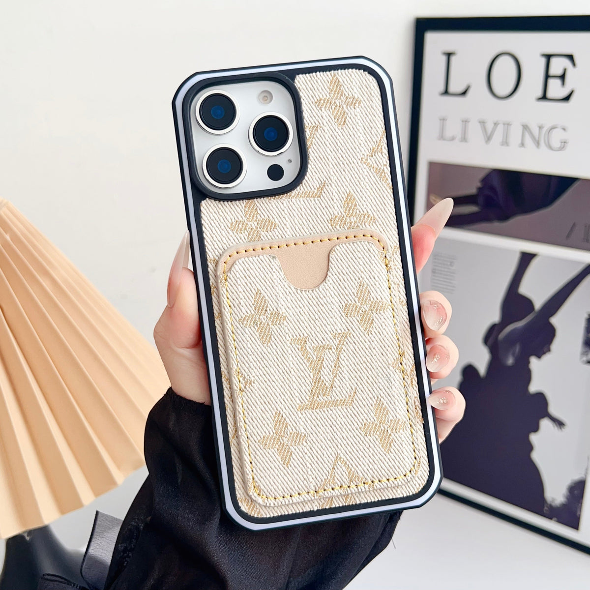 Cream fabric LV iPhone card slot case showing the woven finish and rear card holder