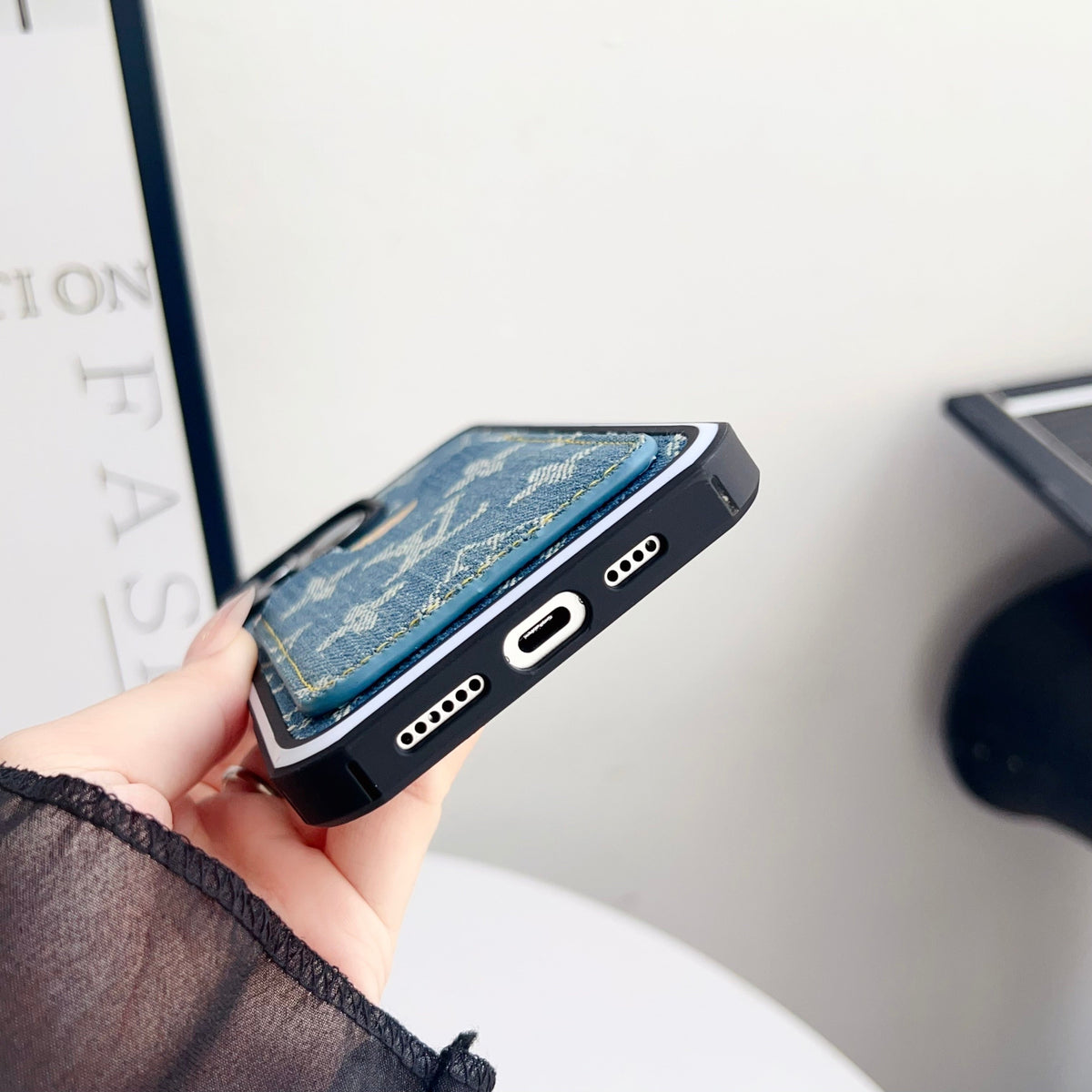 Fabric LV iPhone case with card slot showing clear access to the charging port