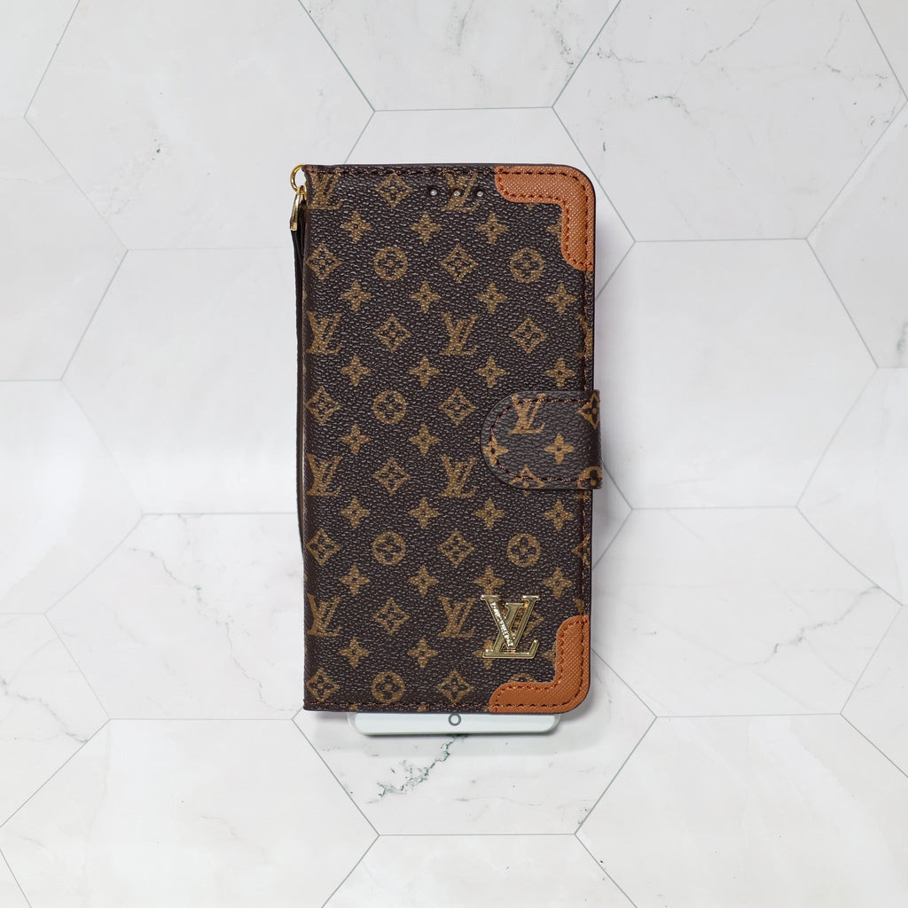LV folio wallet iPhone case with edge patches showing the folding cover and card holder area