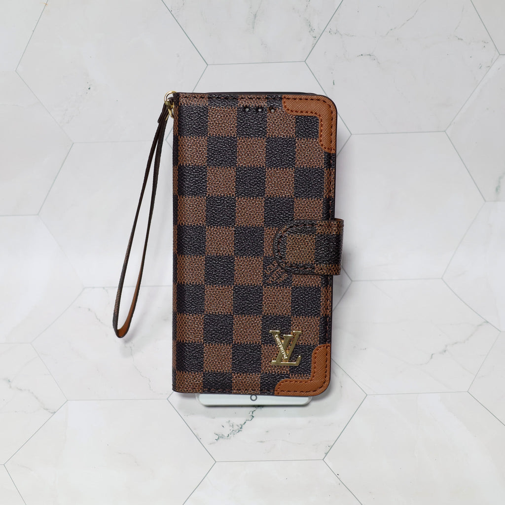 LV folio wallet iPhone case with edge patches showing the fitted phone shell and patterned exterior