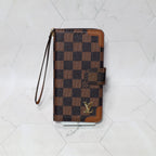 LV folio wallet iPhone case with edge patches showing the fitted phone shell and patterned exterior