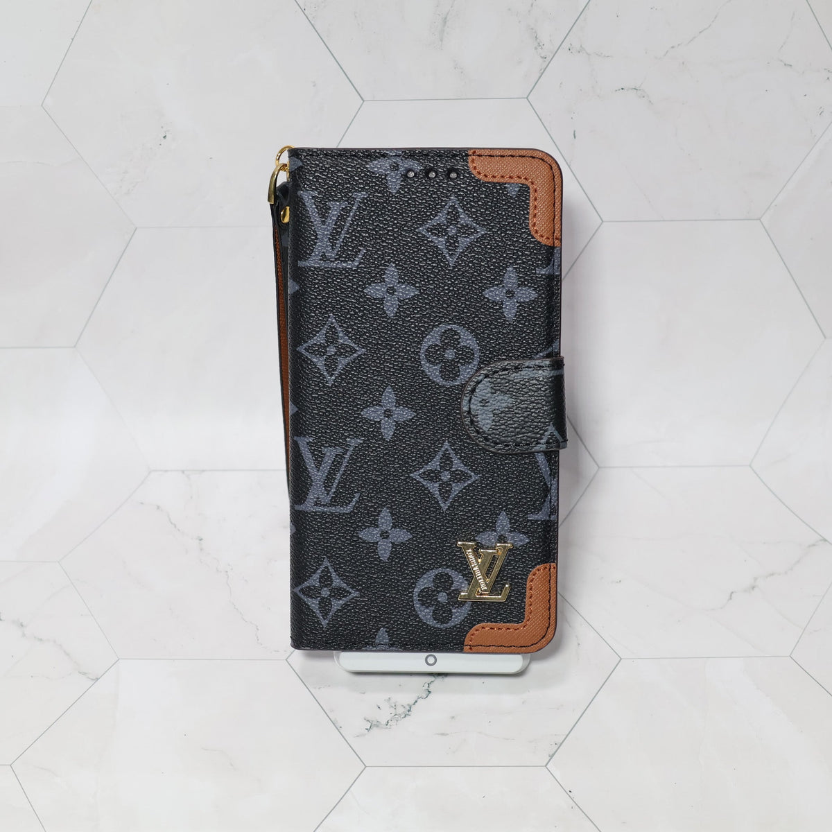 LV folio wallet iPhone case with edge patches close-up showing protective corners and texture