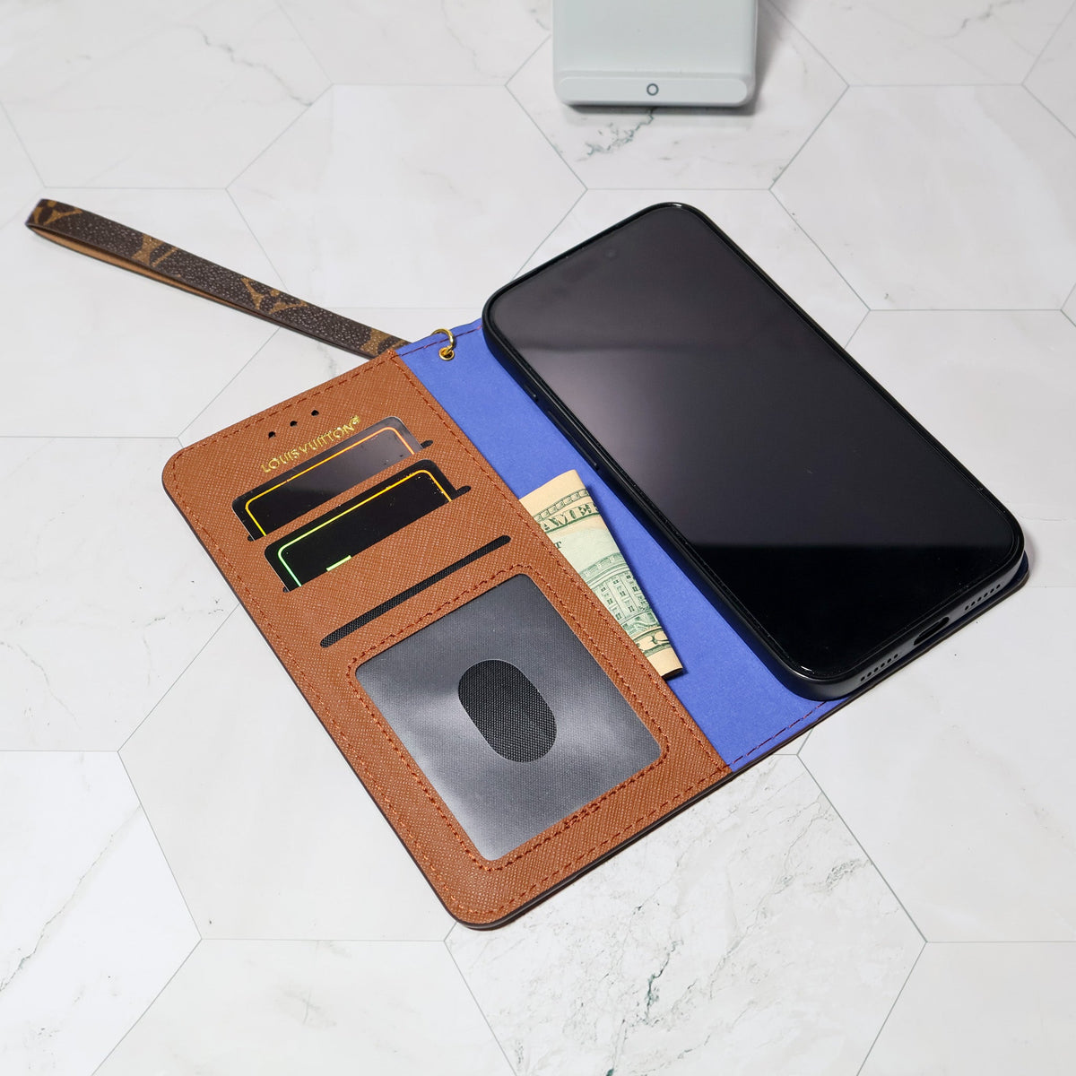 LV folio wallet iPhone case with edge patches showing the fitted camera area and folding cover