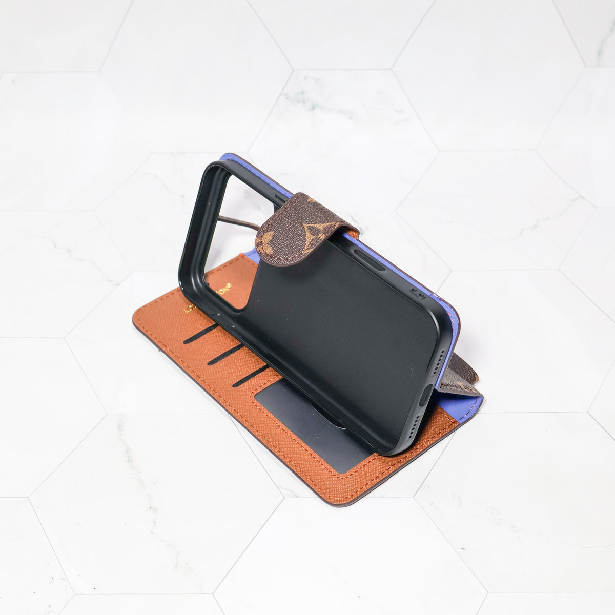 LV folio wallet iPhone case with edge patches showing the slim folding profile and rear cover