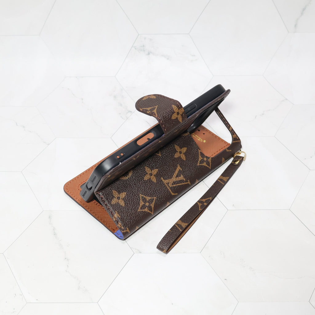 LV folio wallet iPhone case with edge patches close-up showing material texture and card storage