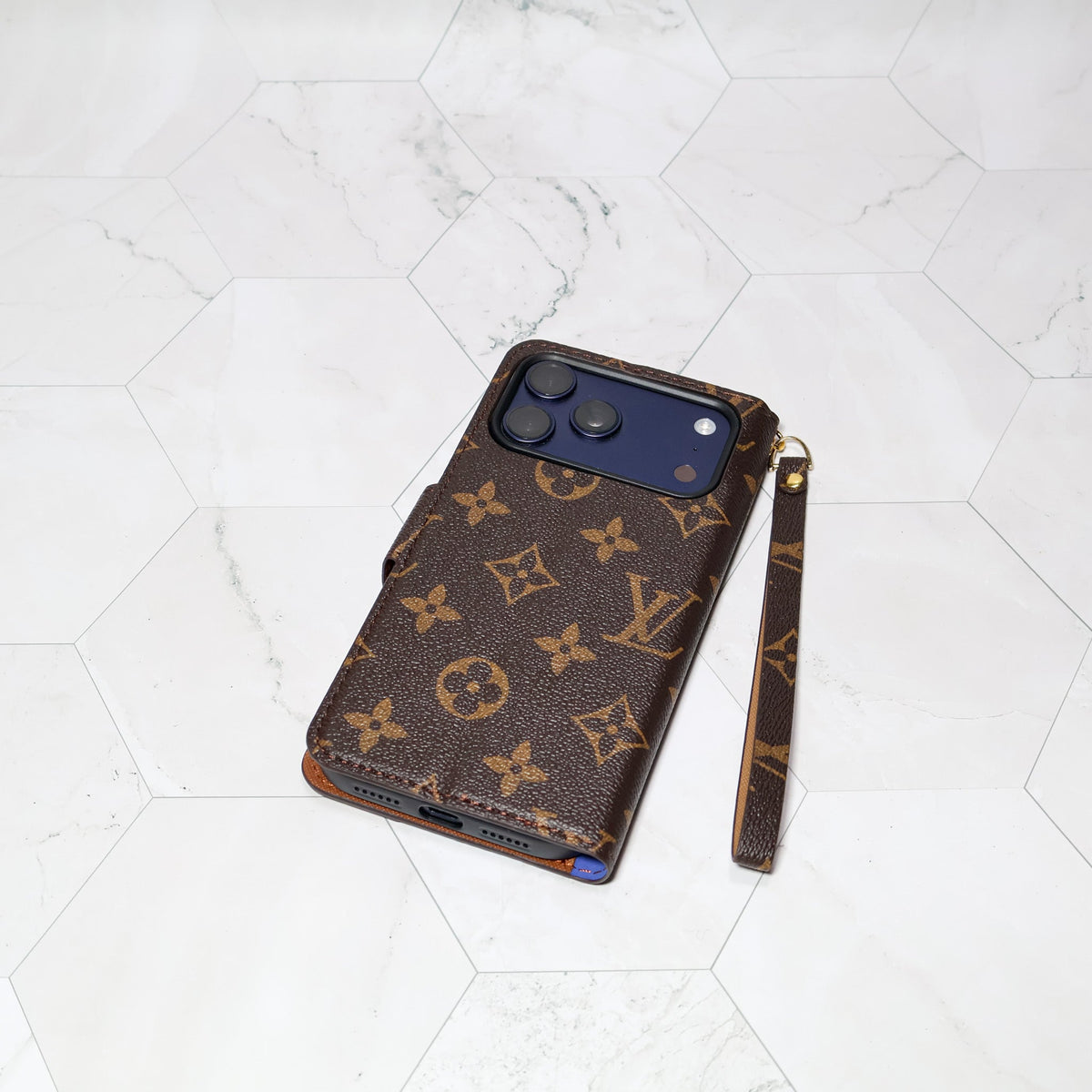 LV folio wallet iPhone case with edge patches showing protective edges and patterned leather finish