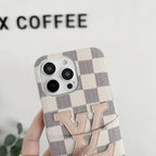 White checkered LV iPhone card holder case showing the camera opening and raised edge