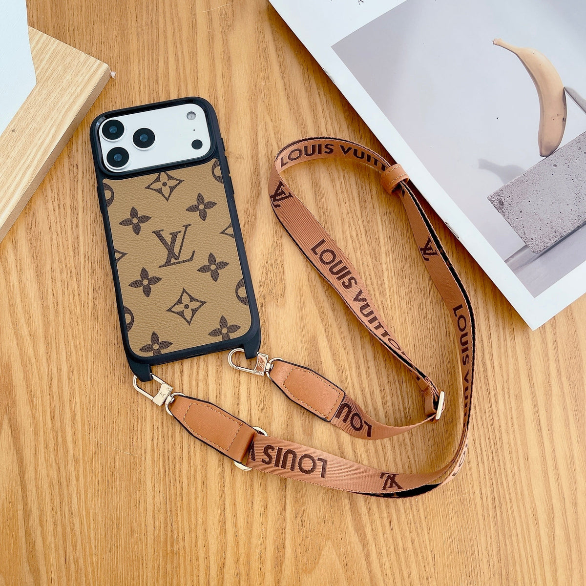 Classic monogram LV crossbody iPhone case showing the patterned leather cover and slim edge profile