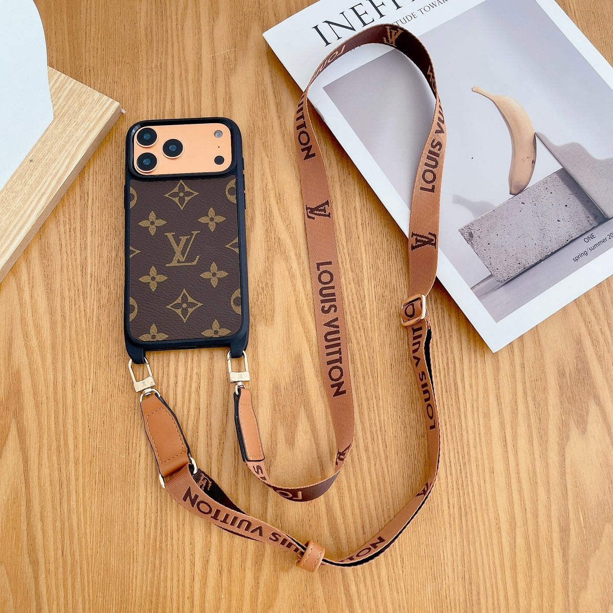 Classic monogram LV crossbody iPhone case showing protective corners and the camera area