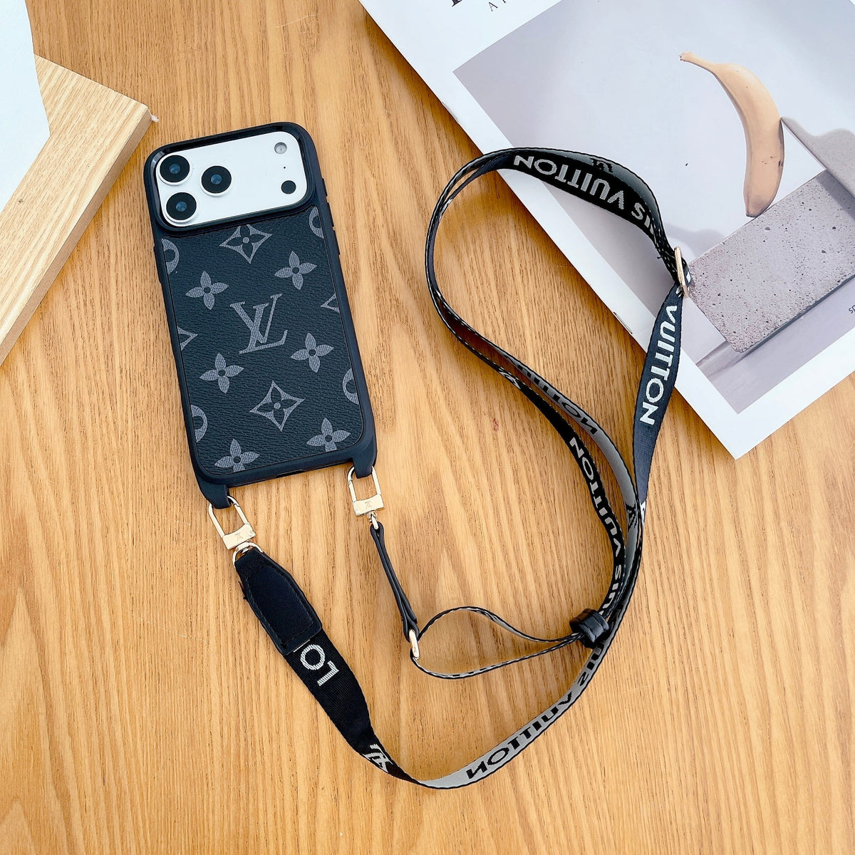 Classic monogram LV crossbody iPhone case showing the carrying strap, camera cutout and fitted edges