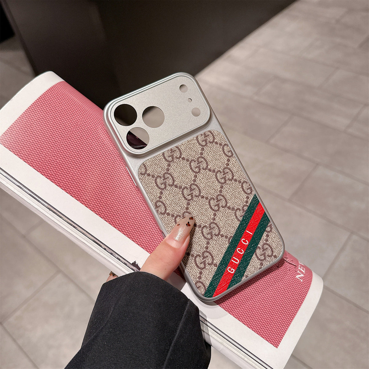 LV lens protection iPhone case showing the camera opening and patterned back design