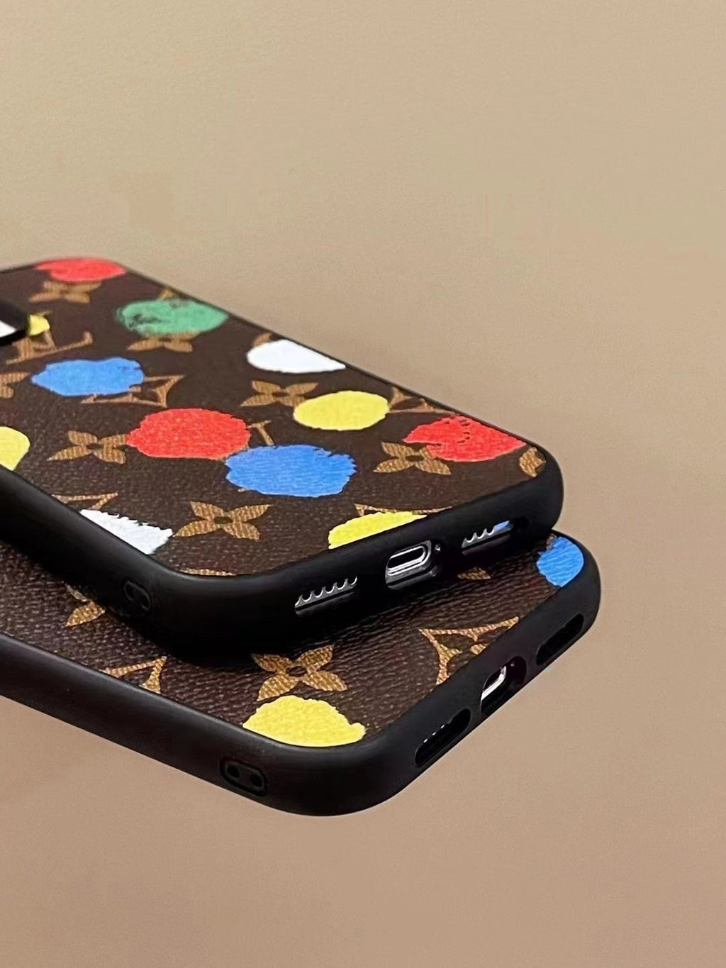 LV paint spots iPhone case showing clear charging port access and protective lower edge
