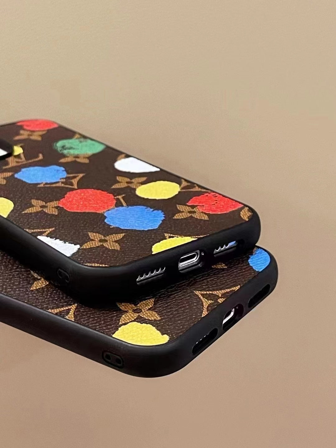 LV paint spots iPhone case showing clear charging port access and protective lower edge