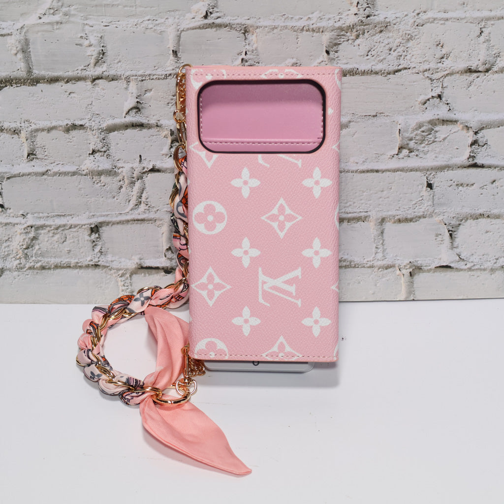 Pink monogram LV crossbody wallet iPhone case showing the strap, camera opening and protective edges