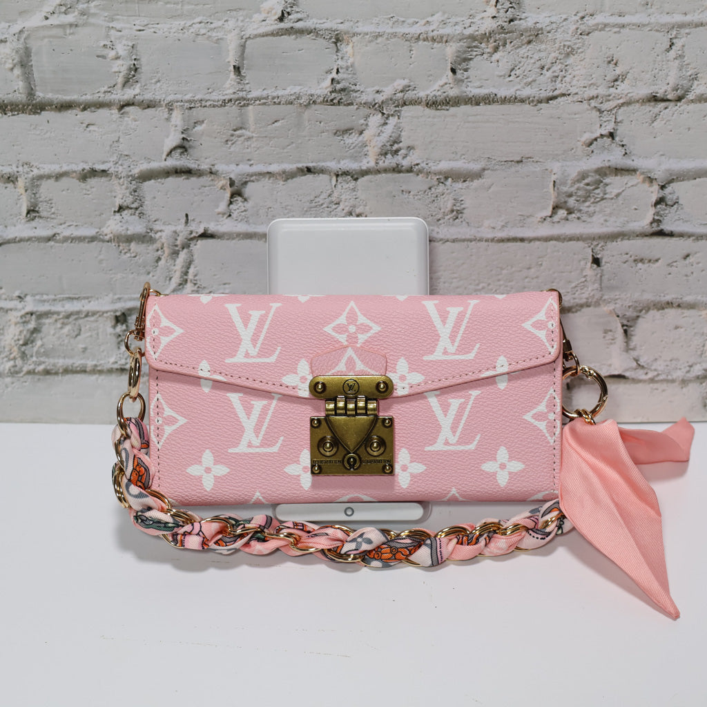 Pink monogram LV crossbody wallet iPhone case shown with the carrying strap and protective back