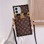 LV trunk iPhone case close-up showing the structured edges and luxury patterned finish