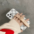 Designer hand strap iPhone case shown in a close-up view of the back cover and finish