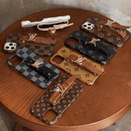 Designer iPhone case with hand strap showing the rear cover and strap attachment detail