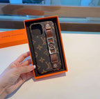 Brown monogram iPhone case with hand strap showing the protective edge and slim fit