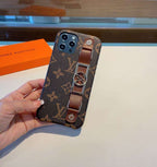 Brown monogram LV iPhone case with hand strap showing the rear pattern and strap detail