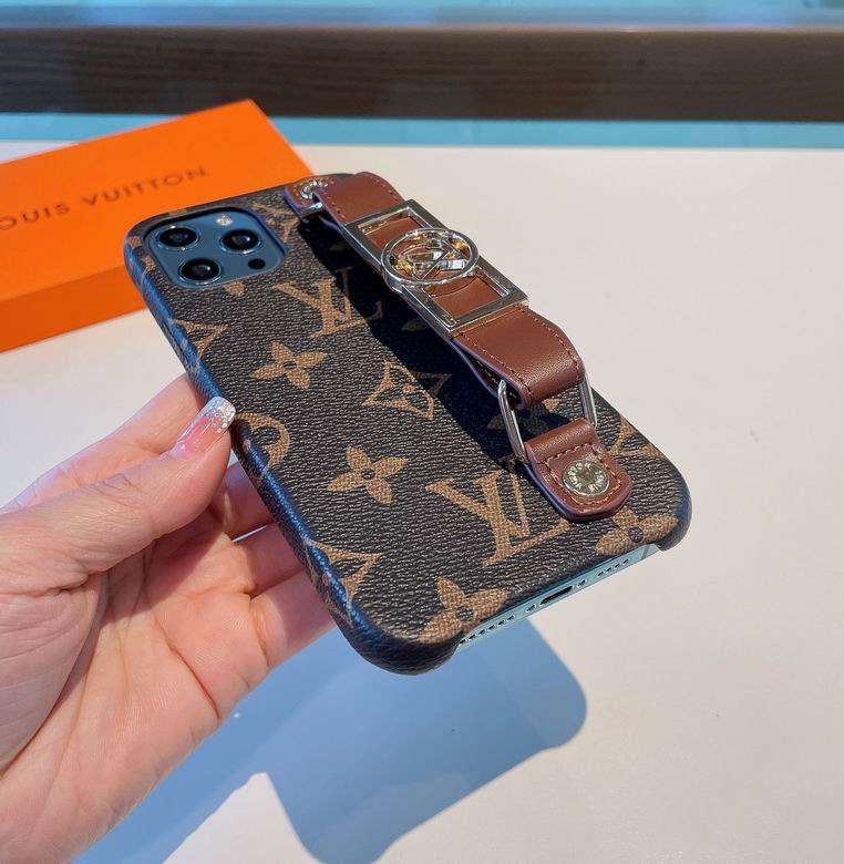 Close-up of the brown monogram iPhone case showing the hand strap and leather finish